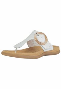 Sandale en plastique blanc avec un accent circulaire transparent, tige en synthétique lisse et semelle en brun texturé, présentant un design minimaliste.