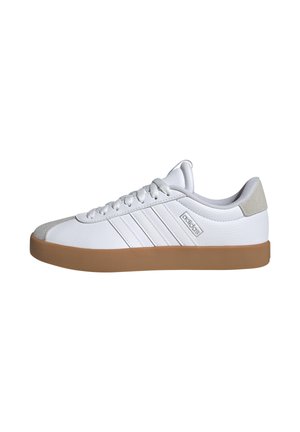 White leather sneakers with a textured surface, gray accents, three stripes design, and a gum rubber sole. Rounded toe and lace-up closure.