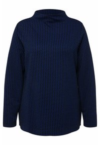 Maglietta a maniche lunghe blu navy con colletto alto, caratterizzata da un pattern houndstooth testurizzato. Taglio ampio con orlo arrotondato. Tessuto morbido.
