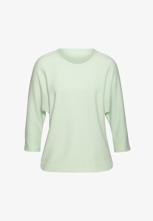 Heled roheline, tekstuuriga top, millel on ümmargune kaelus ja kolmanda sajandi varrukad. Omab laia lõiget ja diskreetset mustrit kogu kanga ulatuses.