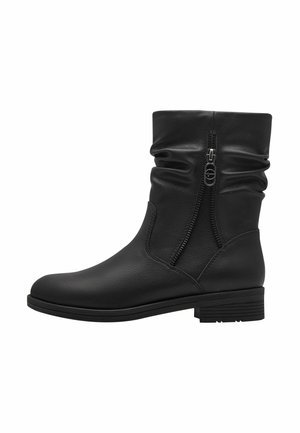 Black leather ankle boots with a slouchy design, double zippers on the side, flat sole, and textured finish.