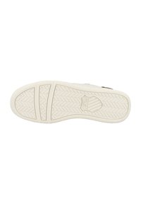 White sneaker sole with a textured herringbone pattern, featuring a logo stamped near the heel and a smooth edge. Durable rubber material.