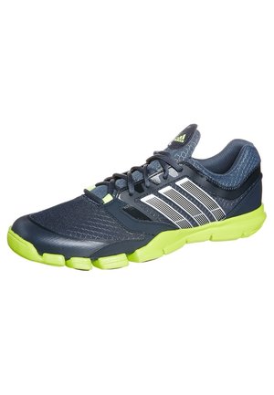 Dunkelblauer Adidas Sneaker mit weißen Streifen und neongrüner Sohle, aus Mesh-Gewebe und mit Schnürdesign.