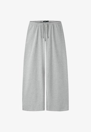 Svetlošedé široké nohavice s elastickým pásom a šnúrkou, vyrobené z mäkkej látky, vhodné na bežné nosenie.