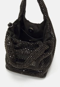 Fekete gyöngyökkel díszített kézitáska, textúrált felülettel, strukturált formával, rövid fogantyúkkal és bélelt belső résszel, patentos záródással.