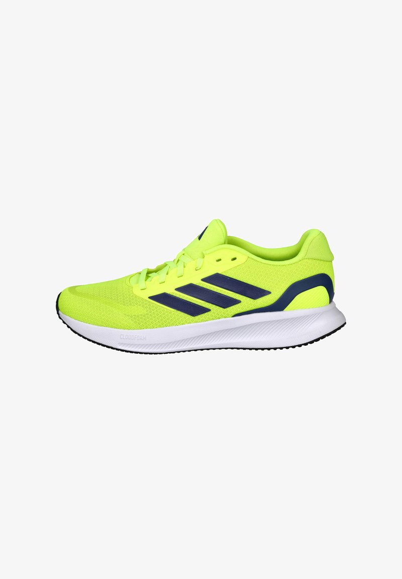 Zapatilla deportiva de color amarillo brillante con parte superior de malla transpirable, detalles en azul oscuro y suela blanca con patrones texturizados para mayor agarre.