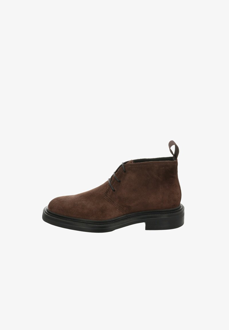Brown suede ankle boots with black rubber soles, featuring a round toe, two eyelets for laces, and a pull tab at the back.