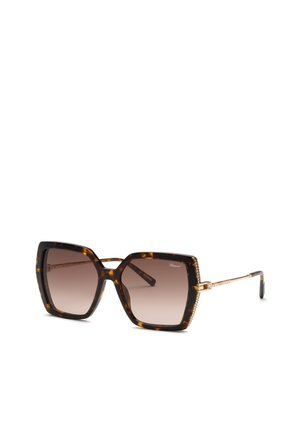 Lunettes de soleil carrées oversize en écaille avec verres marron dégradés et fines branches métalliques dorées ornées de petits cristaux.