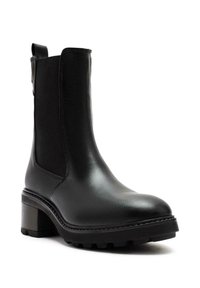 Black ankle boot made of smooth leather with elastic side panels, chunky heel, and rugged outsole for traction. Features minimal stitching detail.