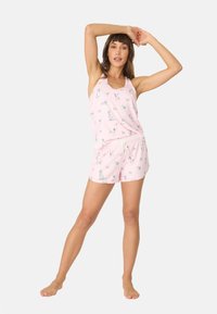 Rosa pyjamaset i mjukt tyg, bestående av en ärmlös topp och shorts med dragsko. Tyget har ett mönster med katt och fjärilar.