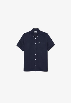 Korte mouwen marineblauwe overhemd met knopen, gemaakt van een gestructureerde stof, met een borstzak en een Lacoste-logo accent aan de linkerzijde.