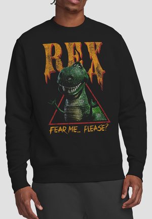 Smiling green T-Rex dinosaur inside red triangle with text "REX" above and "Fear me.. please?" below on black sweatshirt.