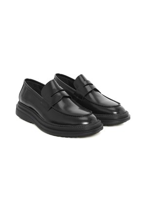 Black leather loafers with a rounded toe, stitched detailing, and a platform rubber sole. Features a decorative strap across the vamp.