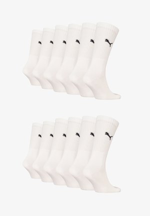 White cotton athletic socks with ribbed cuffs and black Puma logo, arranged in two rows of six pairs.