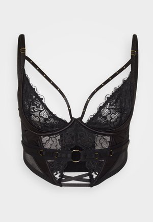 Must pitsiline rinnahoidja raamidega, läbipaistvast kangast, kuldsete detailidega, reguleeritavate rihmade ja rihmakombinatsiooniga põhjas lisaornamendi jaoks.