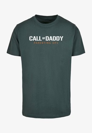 Dark green cotton t-shirt with short sleeves. Front features "CALL of DADDY" in white and "PARENTING OPS" in orange. Round neck.