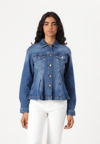 Denim jacket features a fitted design, light blue color, two chest pockets, and copper-tone buttons with a peplum hem.