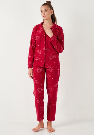 Red pajama set featuring a button-up shirt and pants with a striped pattern. Material appears soft with teddy bear motifs and a relaxed fit.
