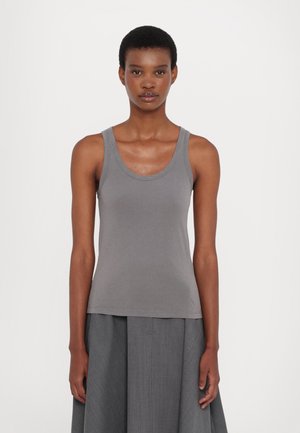 Gray cotton tank top with a round neckline and wide straps, fitted at the torso, paired with a flowing gray skirt. Smooth texture.
