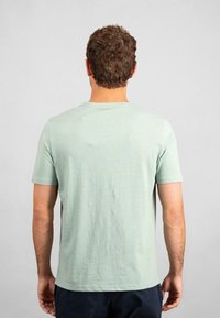 Mint green short-sleeve t-shirt with a round neckline, made of soft fabric, featuring a simple, smooth texture and no visible patterns.