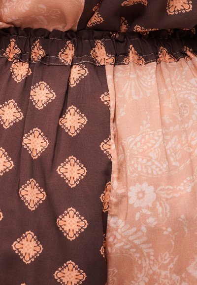 Καφέ και ανοιχτό ροδακινί ύφασμα με λουλουδένια και γεωμετρικά σχέδια· διαθέτει ζωνάρι με πιέτες· λεία υφή με αντίθετα σχέδια.