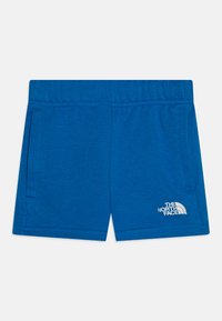 Modré športové šortky vyrobené z mäkkej látky, s elastickým pásom, dvoma bočnými vreckami a bielym logom v pravom dolnom rohu.