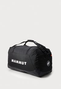 Black duffel bag with textured fabric, featuring a large white "MAMMUT" logo, adjustable straps, and an elephant logo on the side.