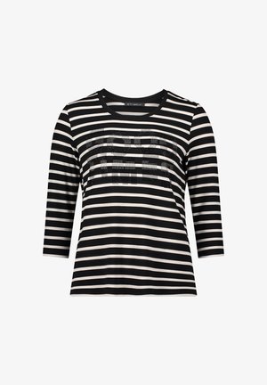 Chemise à manches longues rayée noir et blanc avec un col rond et un design graphique texturé en strass sur la poitrine.