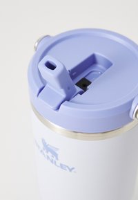 White and lavender Stanley travel mug with a flip-up spout on the lid, viewed close-up from the top-right angle.
