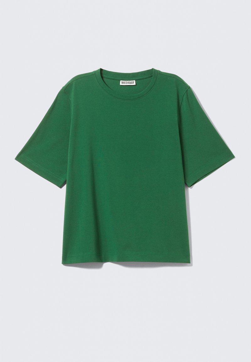 Groen T-shirt met korte mouwen van katoen, met een ronde halslijn en een ontspannen, boxy pasvorm zonder zichtbare patronen of accenten.