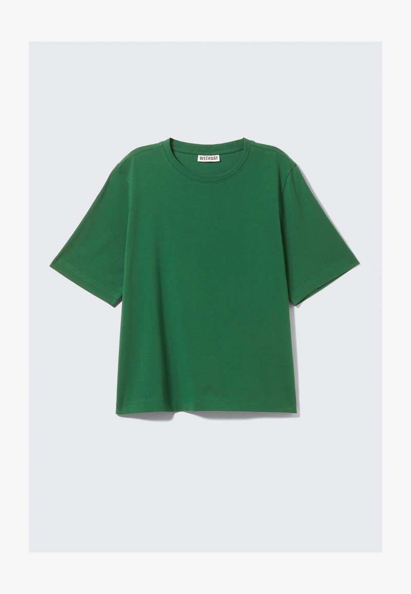 Groen T-shirt met korte mouwen van katoen, met een ronde halslijn en een ontspannen, boxy pasvorm zonder zichtbare patronen of accenten.