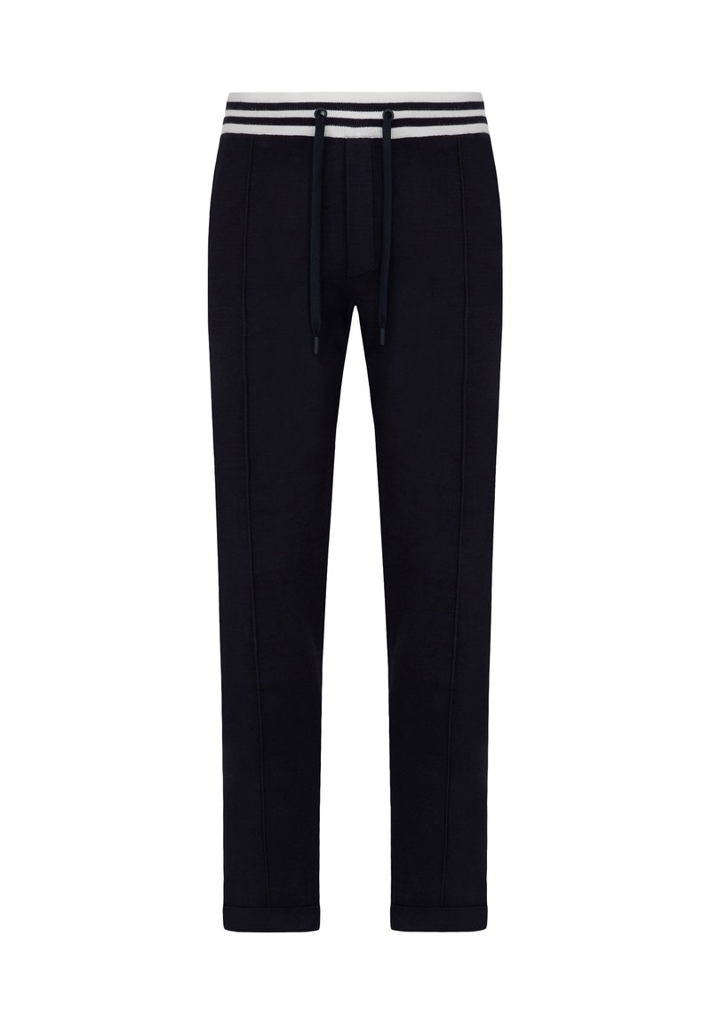 Marineblå sweatpants lavet af blødt stof, med snøre i taljen, hvide og grå striber i taljen og tapered ben-design.