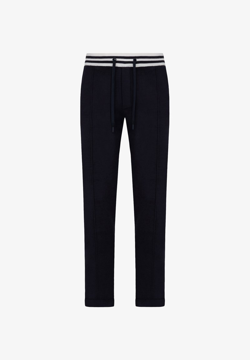 Marineblå sweatpants lavet af blødt stof, med snøre i taljen, hvide og grå striber i taljen og tapered ben-design.