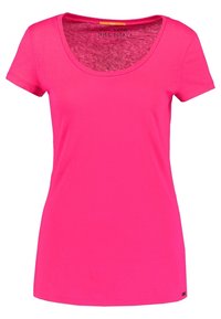 Camiseta de manga corta en tejido de algodón rosa brillante, con escote en pico y una etiqueta con el texto "TE VES BIEN HOY".