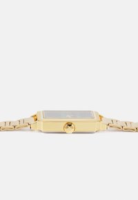 Gold-tone rectangular watch with a textured face, link bracelet, and a side crown. Features glass display and contrasting accents.