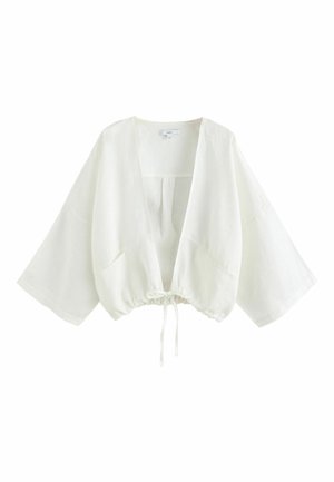 Veste blanche ample style kimono avec manches larges, encolure en V et cordon de serrage réglable à l'ourlet.