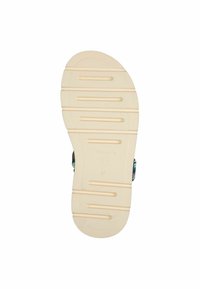 Suola di una scarpa in gomma beige chiaro, con scanalature orizzontali per la trazione e un logo circolare vicino al tallone, taglia contrassegnata come 37.