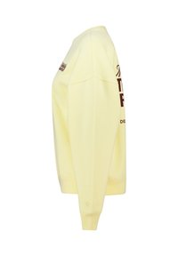 Yellow sweatshirt with a relaxed fit, crew neck, and long sleeves. Features a dark brown graphic print on the front and ribbed cuffs.