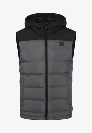 Polstret vest med hette, med en svart øvre del og grå nedre del, laget av glatt stoff med glidelås foran og sidelommer.