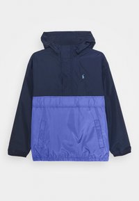 Navy blue and purple hooded windbreaker with a half-zip front, elastic cuffs, and embroidered logo on the chest. Features a smooth, lightweight texture.