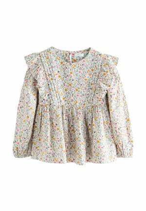 Langärmlige Bluse aus weißem Stoff mit Blumenmuster, die Rüschendetails an den Schultern, eine geraffte Taille und lebhafte Blumenmuster in Pink, Gelb und Grün aufweist.