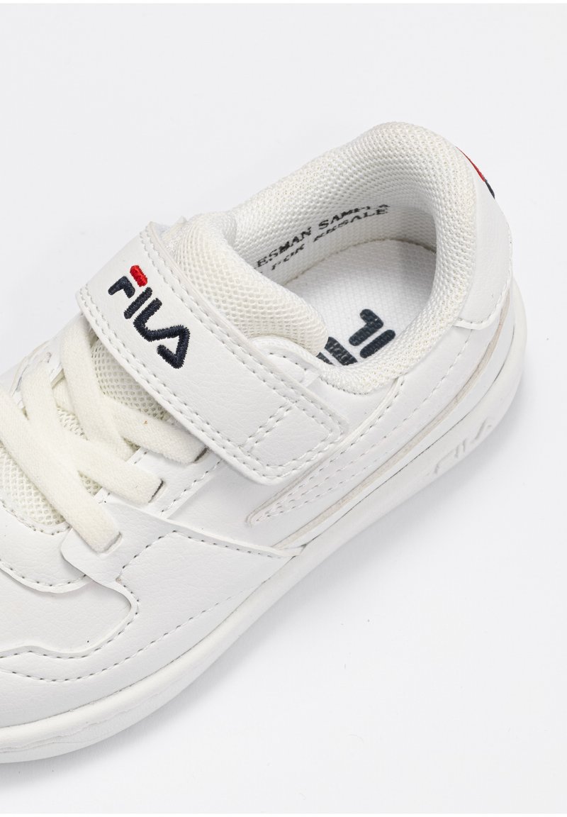 Sneaker bianca in ecopelle con linguetta in rete, presenta una chiusura in Velcro e un logo discreto sul lato e sul tallone. Punta arrotondata.