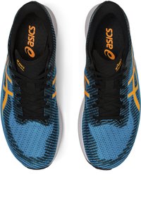 Scarpe da ginnastica blu e nere con una parte superiore in tessuto testurizzato, caratterizzate da un logo arancione e dettagli in arancione, lacci neri e un design di suola bianca.