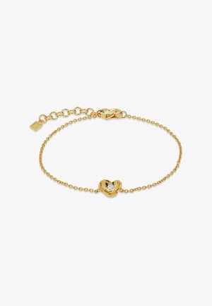 Bracciale a catena d'oro con un piccolo ciondolo a forma di fiore con una pietra centrale chiara e una chiusura regolabile.