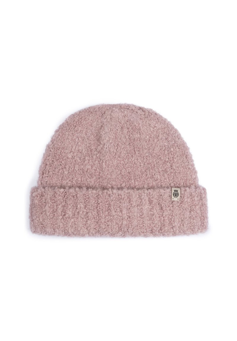 Soft pink curly knit beanie with folded brim and a small fabric tag featuring a logo on the side.