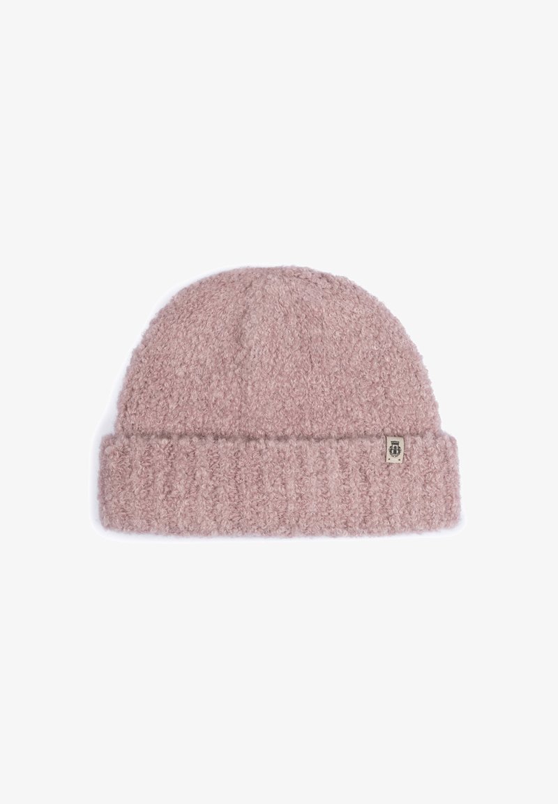 Soft pink curly knit beanie with folded brim and a small fabric tag featuring a logo on the side.