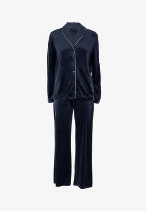 Maglietta da pigiama blu navy in velluto con maniche lunghe e bottoni, abbinata a pantaloni larghi con piping bianco sul colletto e sui bordi frontali.