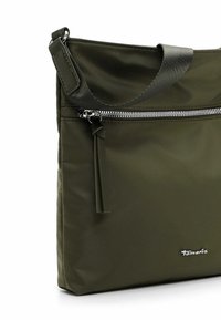 Olive green nylon shoulder bag with a zippered front pocket, flat design, sleek texture, and a branded silver accent.