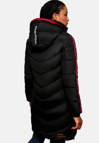 Black puffer coat with a chevron design, red accents along the sleeves, and a hood. Features a logo on the back and textured fabric.
