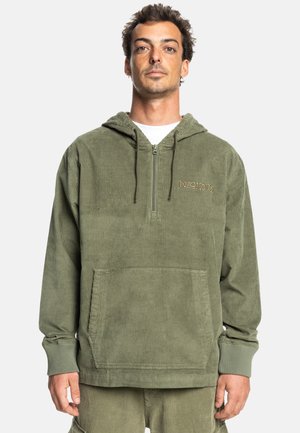 Olive green corduroy hoodie with a half zipper, kangaroo pocket, ribbed cuffs, and embroidered logo on the chest. Soft texture and relaxed fit.
